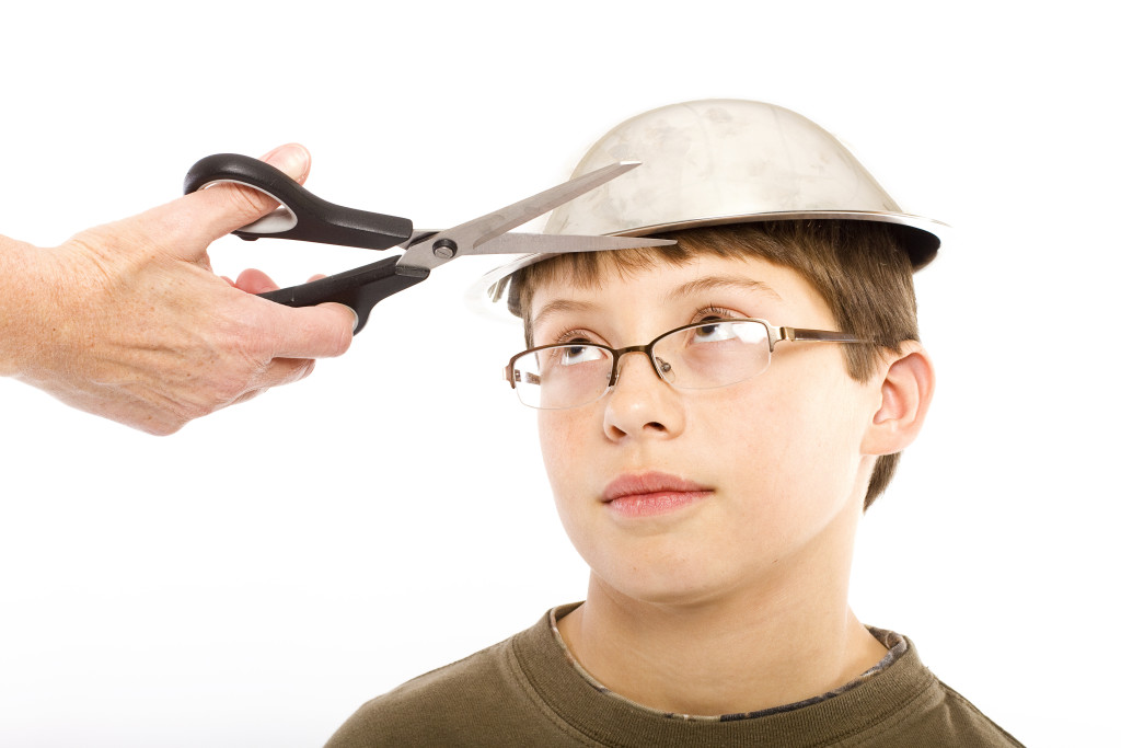 A young boy getting ready for a pudding bowl haircut